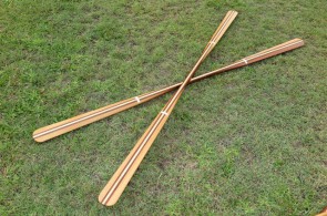 Two custom Greenland paddles made of Western Red Cedar with laminated shafts on display.