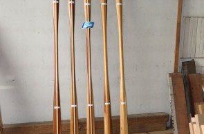 Five custom Greenland paddles made of Western Red Cedar with laminated shafts on display.
